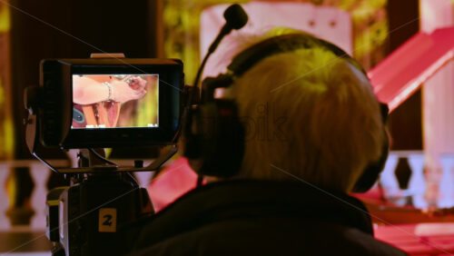 Video - Man filming with professional camera on the backstage of a TV set