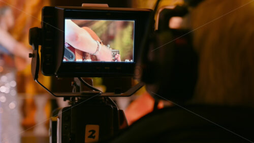 Video - Man filming with professional camera on the backstage of a TV set