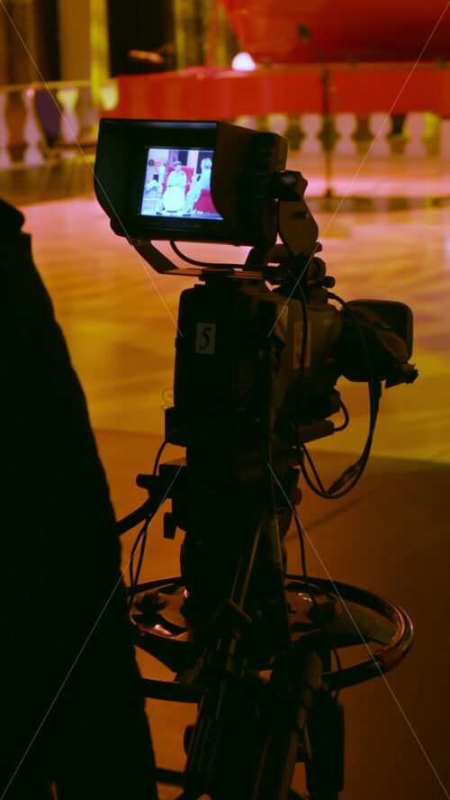 Video - Professional camera filming on the backstage of a TV set. Vertical