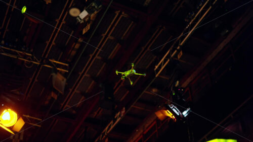 Video - Drone flying and filming near flashing studio lights equipment on the ceiling of a TV set