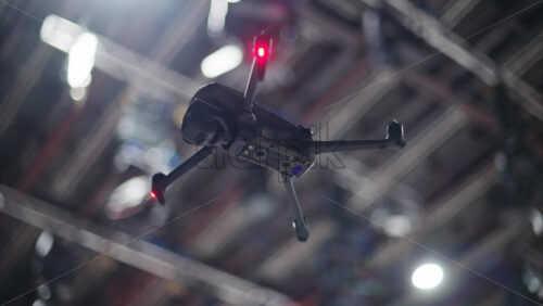 Video - Drone flying and filming near flashing studio lights and camera equipment on a TV set