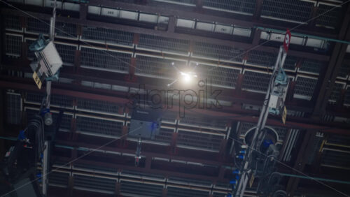 Video - Drone flying and filming near flashing studio lights equipment on the ceiling of a TV set