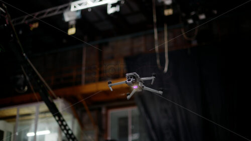Video - Drone flying and filming near flashing studio lights and camera equipment on a TV set