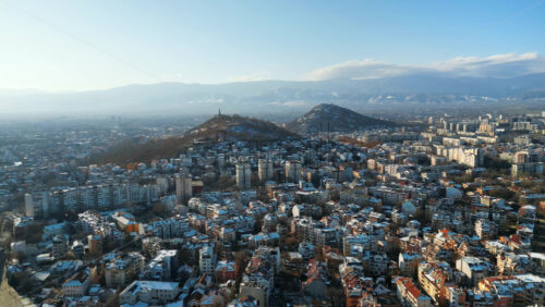 Video - Aerial drone view of Plovdiv city covered in snow. The monument of the Red Army "Alyosha" on Bunarjik Hill. Bulgaria