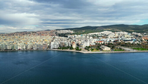 Video - Aerial drone view of Thessaloniki coastline. Monument and museum the White Tower on the waterfront of the city. The Aegean Sea in Central Macedonia in Greece