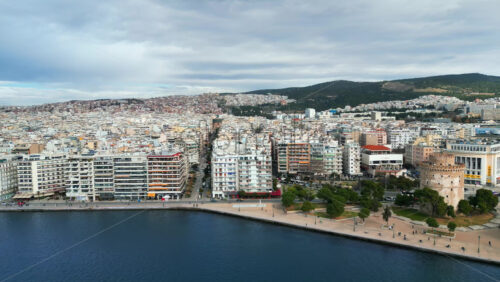Video - Aerial drone view of Thessaloniki coastline. Monument and museum the White Tower on the waterfront of the city. The Aegean Sea in Central Macedonia in Greece