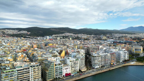 Video - Aerial drone view of Thessaloniki coastline. Green hills in background. The Aegean Sea in Central Macedonia in Greece