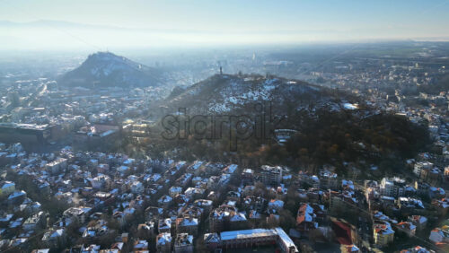 Video - Aerial drone view of Plovdiv city covered in snow. The monument of the Red Army "Alyosha" on Bunarjik Hill. Bulgaria