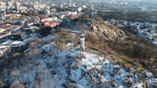 Video - Aerial drone view of the clock tower on top of Sahat Tepe. Clock Hill covered in snow in Plovdiv, Bulgaria
