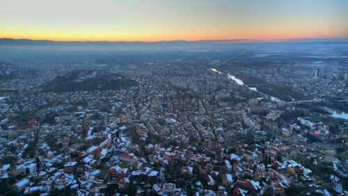 Video - Aerial drone view of Plovdiv city covered in snow at sunset. Bulgaria