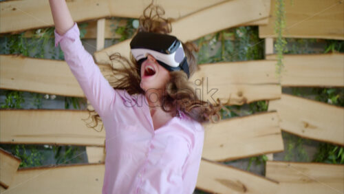 Video - Woman looking through VR headset and jumping on bed