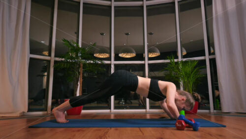 Video - Young woman girl doing cobra movement in yoga. City on background. Night