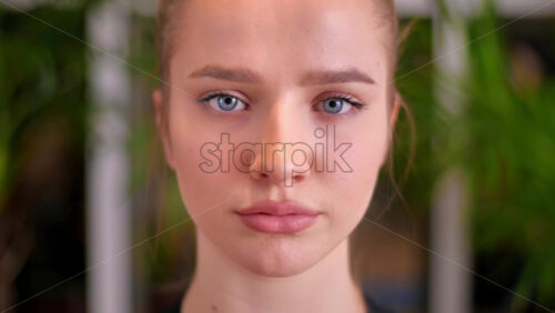 Video - Close up portrait of young woman girl face with blue eyes. Indoor apartment at night