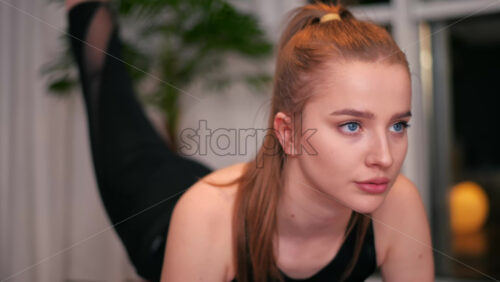 Video - Young woman girl exercising at home. Indoor training at home, quarantine. Night