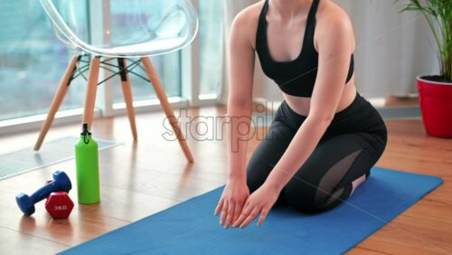 Video - Young girl stretching and doing yoga indoors in apartment