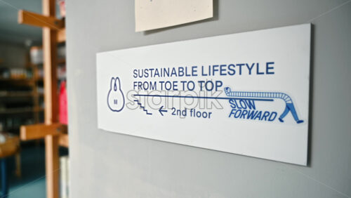Video - Bucharest, Romania - March 02, 2024: Metal sign mounted on a wall supporting sustainable lifestyle education