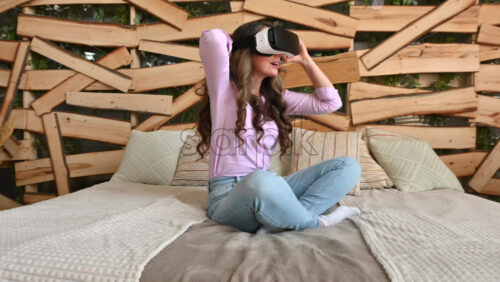 Video - Woman putting on VR headset and enjoying it