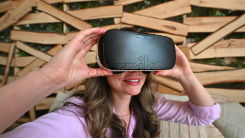 Video - Woman putting on VR headset and enjoying it