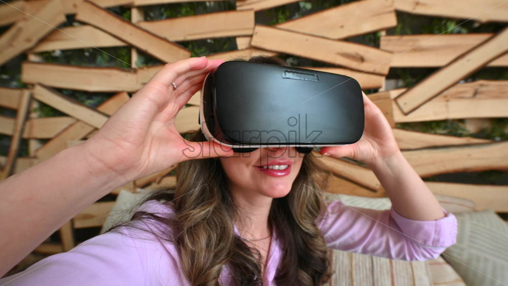 Video - Woman putting on VR headset and enjoying it