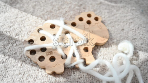 Video - Ecological wooden sheep with a white string toy
