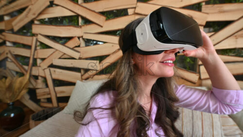 Video - Woman putting on VR headset and enjoying it