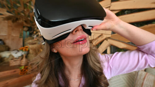 Video - Woman looking thorough VR headset and being impressed