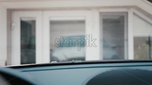 Video - Interior perspective of windshield wipers in motion, cleaning raindrops from a car's window