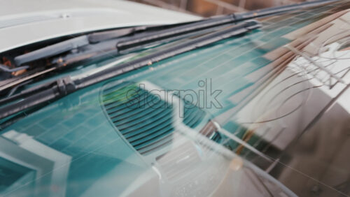 Video - Close up of windshield wipers gliding across glass, reflecting clear visibility and care