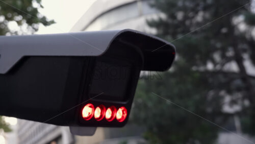 Video - Close up of a security camera with red infrared lights glowing with a blurred background