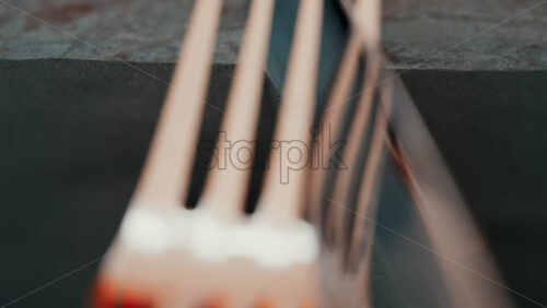 Video - Close up of silver cutlery placed neatly on a dark napkin at a restaurant