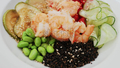 Video - Healthy shrimp bowl with tomatoes, quinoa, edamame, and zucchini