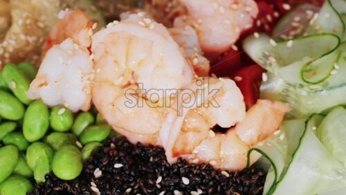Video - Healthy shrimp bowl with tomatoes, quinoa, edamame, and zucchini