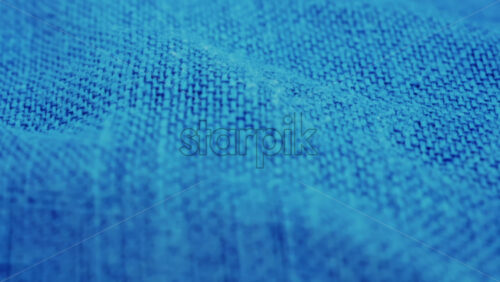 Video - Close up of blue denim fabric texture showing fine threads and detailed textile pattern