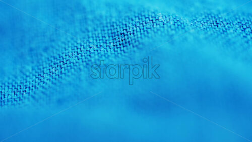 Video - Close up of blue denim fabric texture showing fine threads and detailed textile pattern