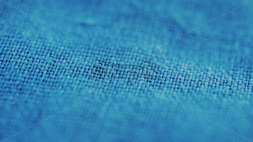 Video - Close up of blue denim fabric texture showing fine threads and detailed textile pattern
