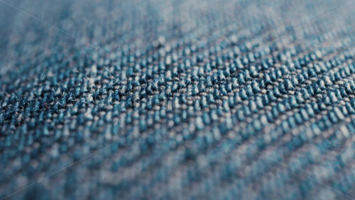Video - Close up of blue denim fabric texture showing fine threads and detailed textile pattern