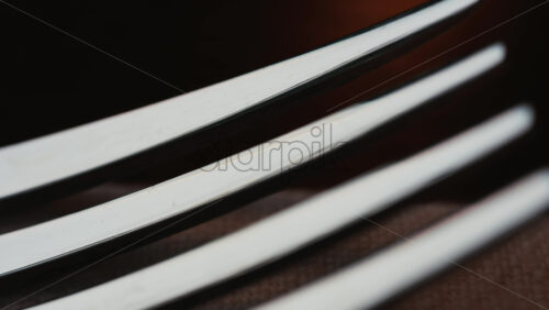 Video - Close up of fork tines with soft reflections