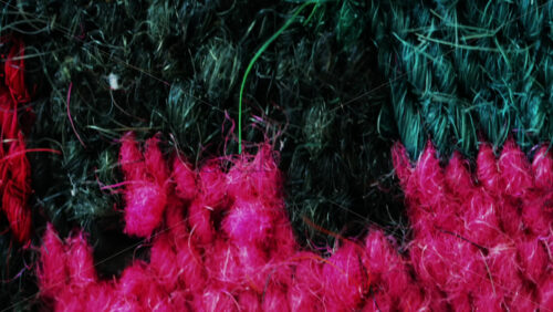 Video - Intense pink and red wool fibers form a rich, detailed texture