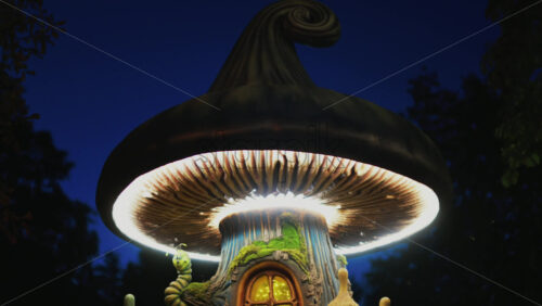 Video - A miniature fantasy tree house with glowing windows, mushrooms, and a smiling caterpillar figure