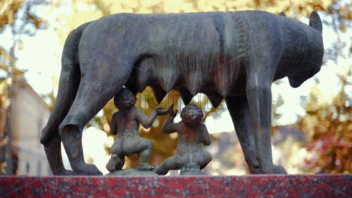 Video - Chisinau, Moldova - September 25, 2025: Historic bronze statue of the Capitoline Wolf with Romulus and Remus on a red marble pedestal in front of the National History Museum of Moldova