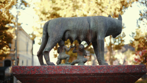 Video - Chisinau, Moldova - September 25, 2025: Historic bronze statue of the Capitoline Wolf with Romulus and Remus on a red marble pedestal in front of the National History Museum of Moldova