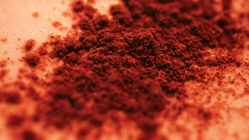 Video - Close up of cocoa sprinkled over frothy milk, with rich warm tones