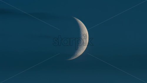 Video - Close up of crescent moon illuminated against a deep blue sky