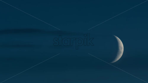 Video - Close up of crescent moon illuminated against a deep blue sky
