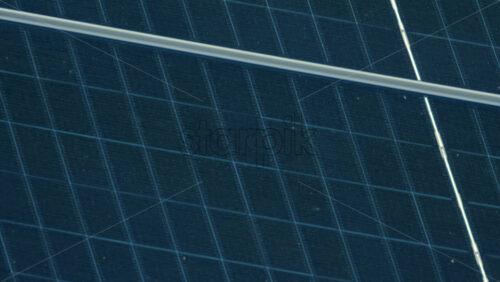 Video - Aerial view of solar panels and rooftop patterns in the sunlight