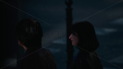 Video - Chisinau, Moldova - September 30, 2025: Two young people walking on a pedestrian crossing in daylight