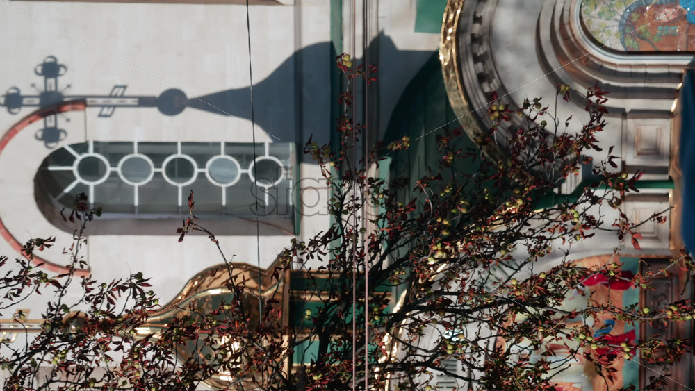 Video - Beautiful architectural detail showing the shadow of a church cross projected on a wall with circular windows. Vertical