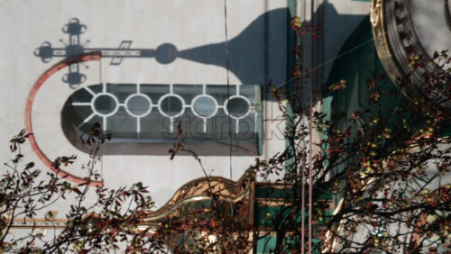 Video - Beautiful architectural detail showing the shadow of a church cross projected on a wall with circular windows. Vertical