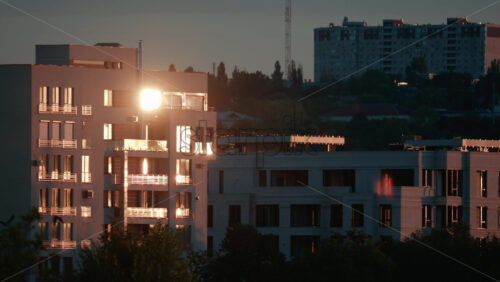 Video - Evening light reflecting off modern apartment buildings, creating a golden glow across the cityscape
