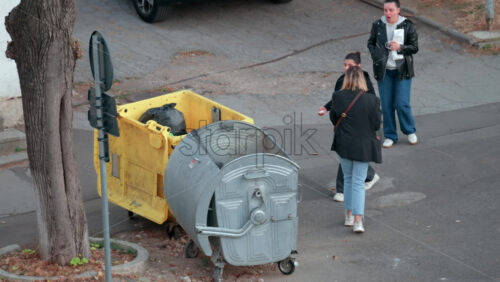 Video - Chisinau, Moldova - September 30, 2025: Three women throwing the trash into a grey bin